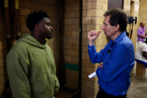Associate Producer Jacory Martin and producer Tony Bennis discuss a scene in the film Bash Town with producer Dean Huh in the background photo by Bruno Dos Santos